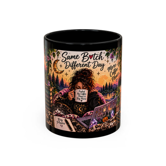 A black ceramic mug featuring a colorful, detailed illustration of a woman reading under a crescent moon with the text 'Same B*tch Different Day' and 'More Coffee Than Tea' on a white background.