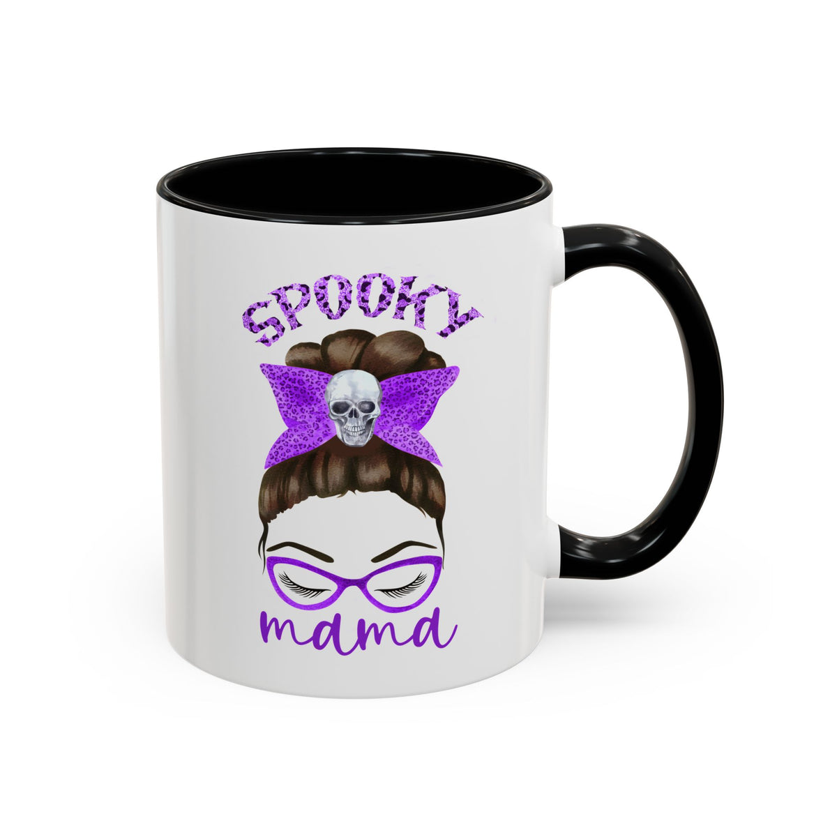 A white ceramic mug with a black handle and black interior, featuring a graphic of a woman's face with glasses, brown hair in a bun, a purple bow with a skull, and the text 'SPOOKY mama' in purple.