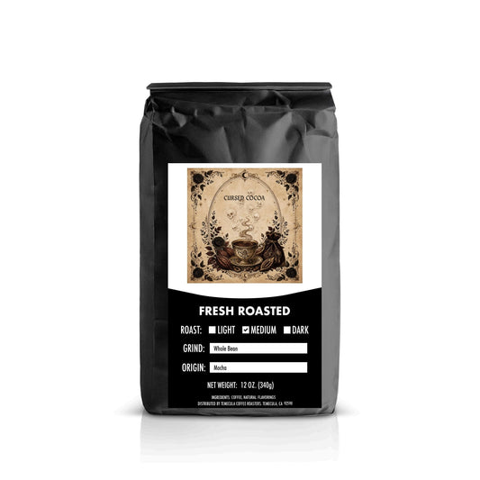 A 12 oz black bag of Cocoa Fresh Roasted coffee on a white background with a subtle reflection.